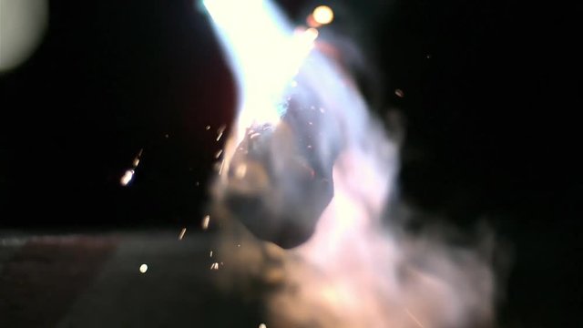 Torch heating up piece of metal.