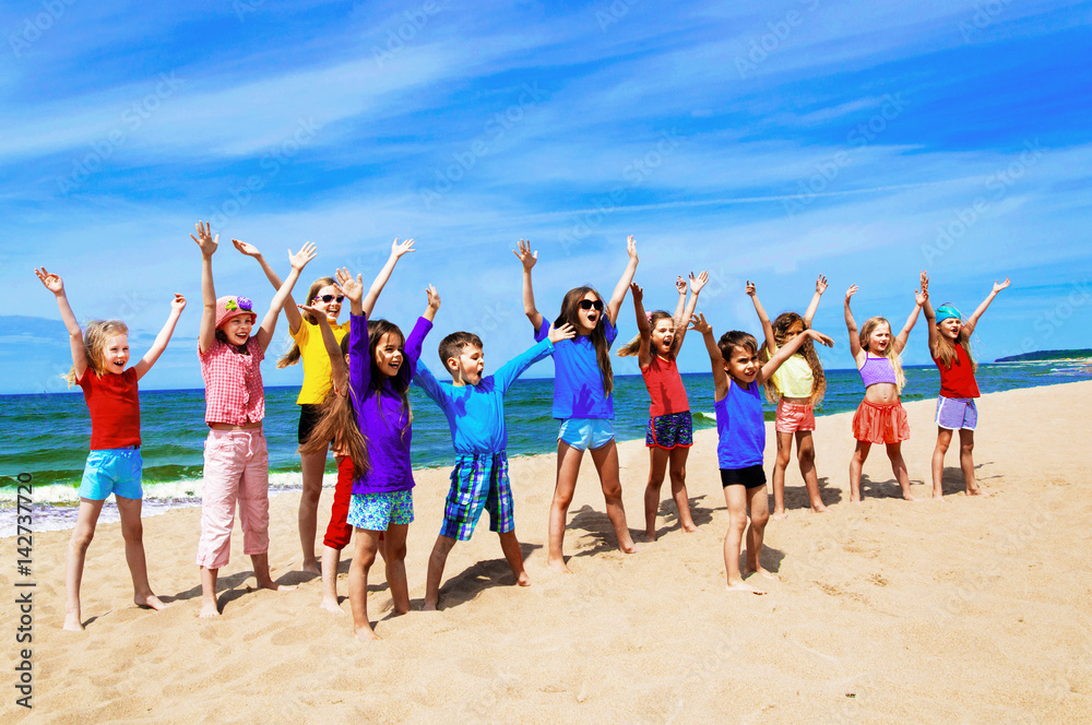 Wall mural Active happy children on the beach