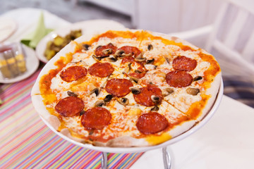 Pizza with salami, cheese and champignons