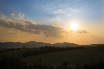 Sunset on meadow with hills and tree. Slovakia