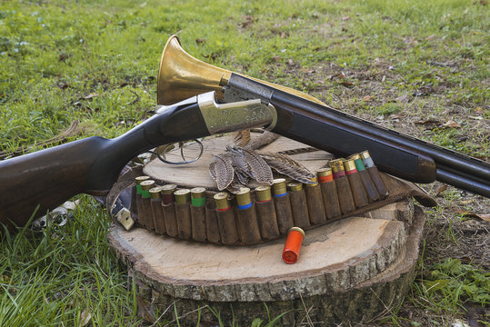hunting concept/hunting rifle and hunting equipment on a stump outdoors