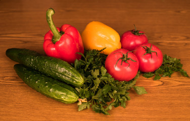 Ripe vegetables lie on the table. Mature and fresh vegetables lie on a wooden board. Appetizing vegetables for salad. Agricultural products