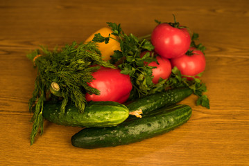 Ripe vegetables lie on the table. Mature and fresh vegetables lie on a wooden board. Appetizing vegetables for salad. Agricultural products