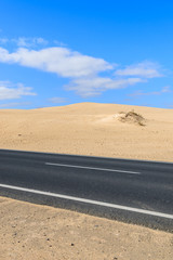 Road in desert landscape of sand dunes in Corralejo National Park, Fuerteventura, Canary Islands, Spain