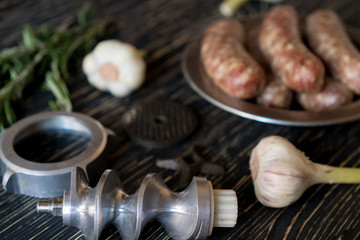 raw sausages , garlic, rosemary and old meat grinder parts