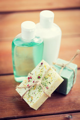 close up of handmade soap bars and lotions on wood