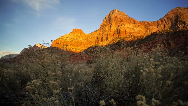 Timelapse of sunset lighting up the cliff face in zion national park.