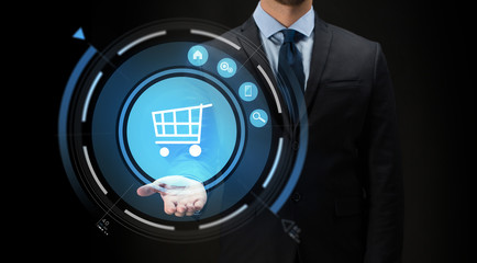 businessman with virtual shopping cart projection