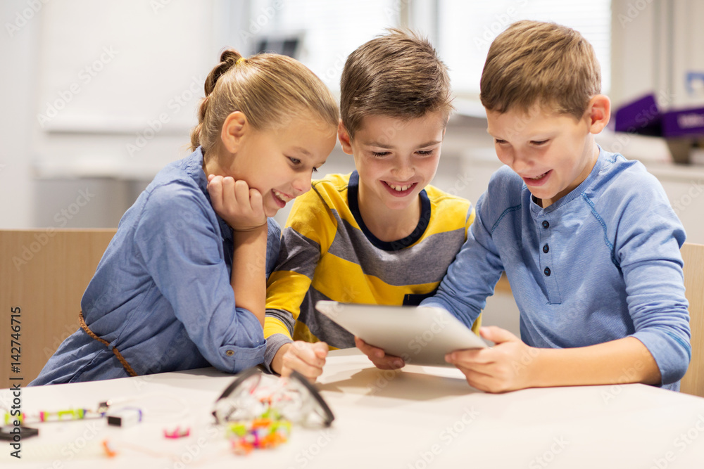 Wall mural kids with tablet pc programming at robotics school