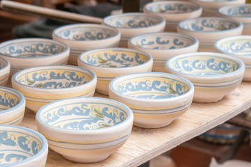 Closeup view of some decorated ceramic bowls in a workshop of Caltagirone, Sicily