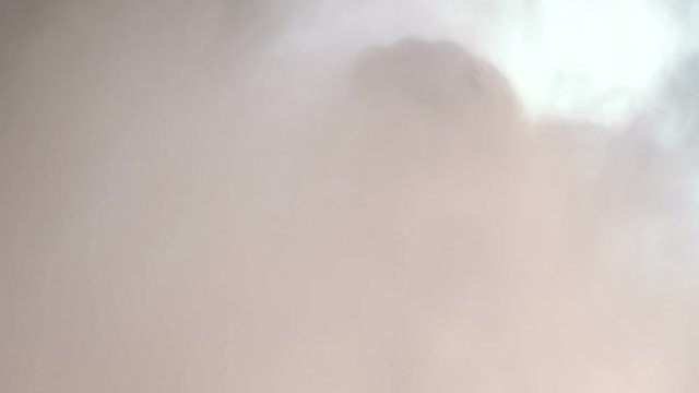 Man's head getting hit from behind by a cloud of dirt