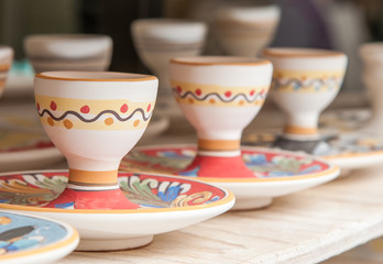 Closeup view of some decorated ceramic egg cups in a workshop of Caltagirone, Sicily