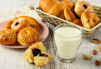 Healthy breakfast ingredients. Homemade fresh fragrant buns and milk . The food is rich in useful carbohydrates, vitamins and nutrients that are essential for health.