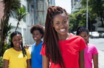 Beautiful african american woman with dreadlocks and other girls