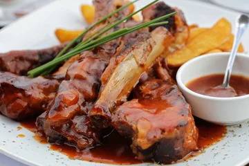 Fototapeten Roasted sliced pork ribs with barbecue sauce © dream@do