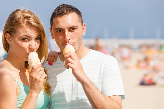 Man and woman eating ice cream on beach Stock Photo | Adobe Stock