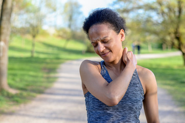 Young african woman holding her neck