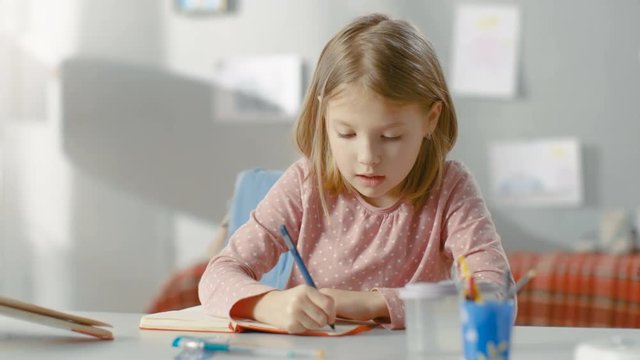 Smart Little Girl Writes in Her Diary while Sitting in Her Room. Shot on RED EPIC-W 8K Helium Cinema Camera.