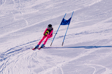 People are enjoying downhill skiing and snowboarding 