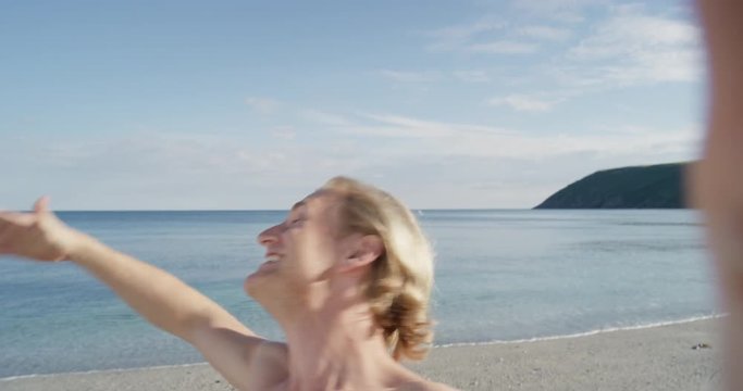 Man taking selfie using phone on beach at sunset smiling enjoying nature and lifestyle on vacation