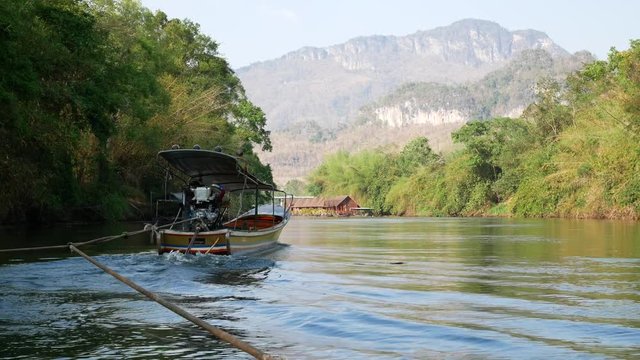 Wide angle footage of boating and rafting trip along River Kwai in Kanchanaburi, Thailand. 4K movie