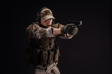 Portrait soldier or private military contractor holding sniper rifle. war, army, weapon, technology and people concept. Image on a black background.