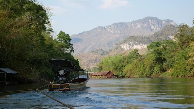 Wide angle footage of boating and rafting trip along River Kwai in Kanchanaburi, Thailand. 4K movie