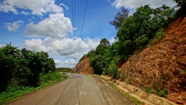 Motion along Country Road to Skyline past Forestry Hilly Slopes