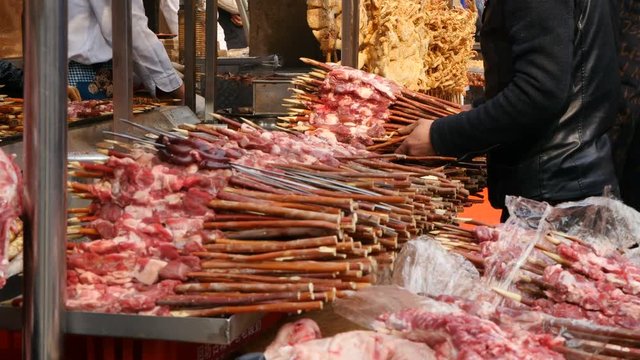 Stacks of meat skewers prepped on tabel on Beiyuanmen Moslem Street, Muslim Quarters, Xi'an China