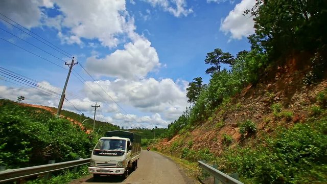 Motion along Road to Skyline past Lorry Scooters Hilly Slopes