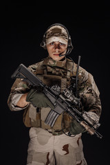Portrait soldier or private military contractor holding sniper rifle. war, army, weapon, technology...