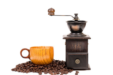 manual coffee grinder and coffee cup on white background