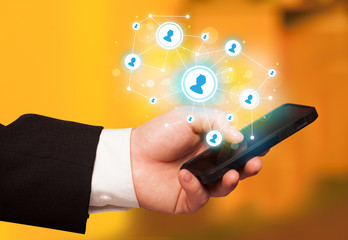 Finger pointing on smartphone, social network concept