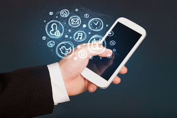 Hand holding smartphone with mobile app choices