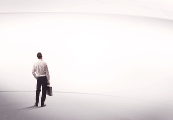 Businessman with briefcase standing still