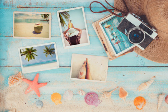 Top view composition - Summer photo album with starfish, shells, coral and items on wooden table. Concept of remembrance and nostalgia in summer tourism, travel and vacation. vintage color tone.