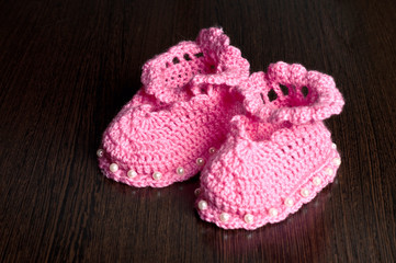 Fototapeta na wymiar knitted, pink booties for children