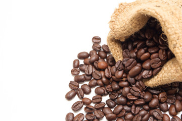Organic coffee beans and wooden coffee dipper on white background close up isolated.