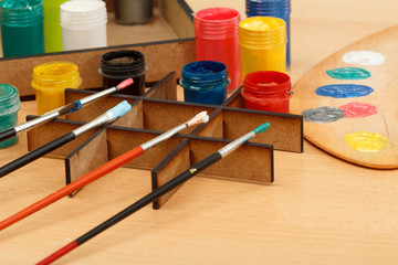 Motley paints and brushes ready for painting