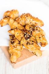 Close up of homebaked mini croissants covered with seeds mix. Morning breakfast.
