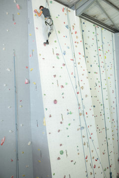 Person at top of indoor climbing wall