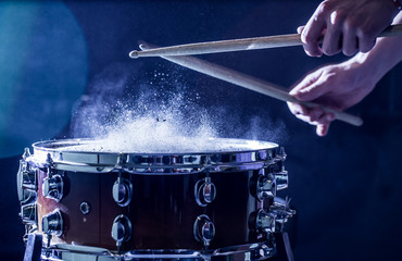 man plays musical percussion instrument with sticks, a musical concept, beautiful lighting on the...