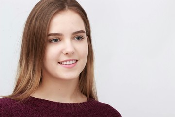 Portrait of a young attractive woman in red sweater