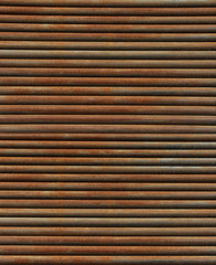Obraz premium Low angle vertical medium close up perspective of thin semi-rusty steel bars stacked in a horizontal position