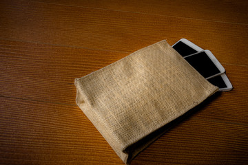 Smartphone in retro burlap bag