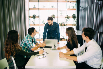 Young group of people discussing business plans.