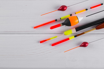 Set of fishing floats  on a wooden white background. © Iryna