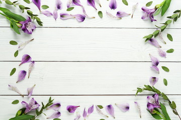 Frame from a floral pattern of lilac on a white wooden background.Top view.Flat lay.Holiday concept.Copy space 
