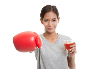 Young Asian woman with tomato juice and boxing glove.