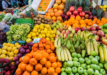 A wide variety of fruits in trays on the market.